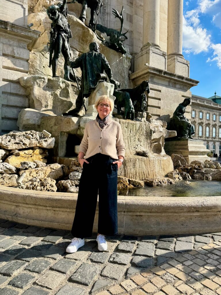 Outfitinspirationen 16/26-von brr bis hui-lifewithaglow-weite dunkle Jeans-Strickjacke beige in leichtem Bouclé-weiße Sneaker-Trenchcoat dunkelblau