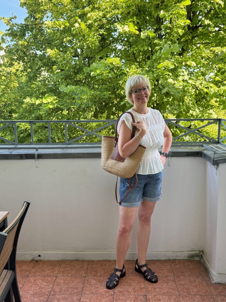 Outfitinspirationen 26. Woche 2026-Halbzeit-Sommer-lifewithaglow-Jeansshorts-gesmokte Bluse-Korbtasche-Fishermans Sandalen